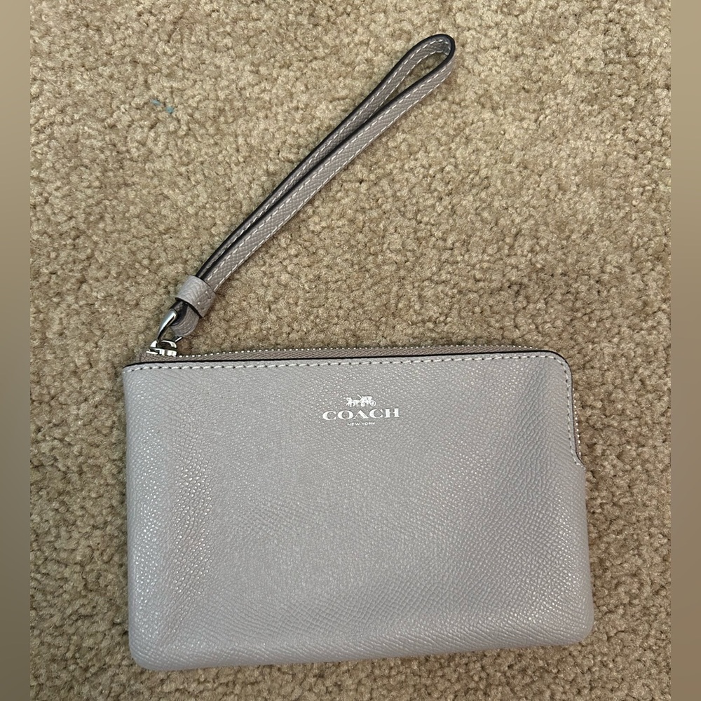 NWT. Coach small mauve/gray wristlet. Never used.